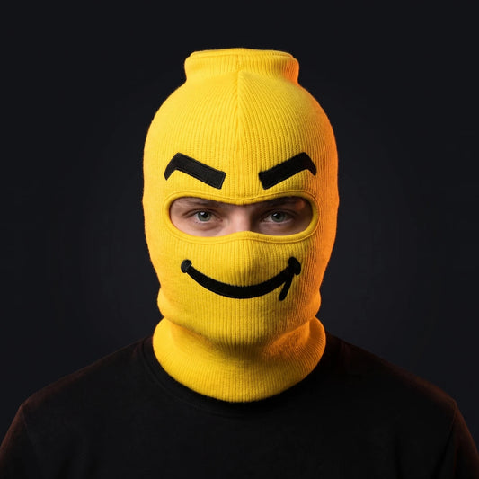 Person wearing the Smuggles ski mask, straight-on, real eyes visible through the open eye opening.