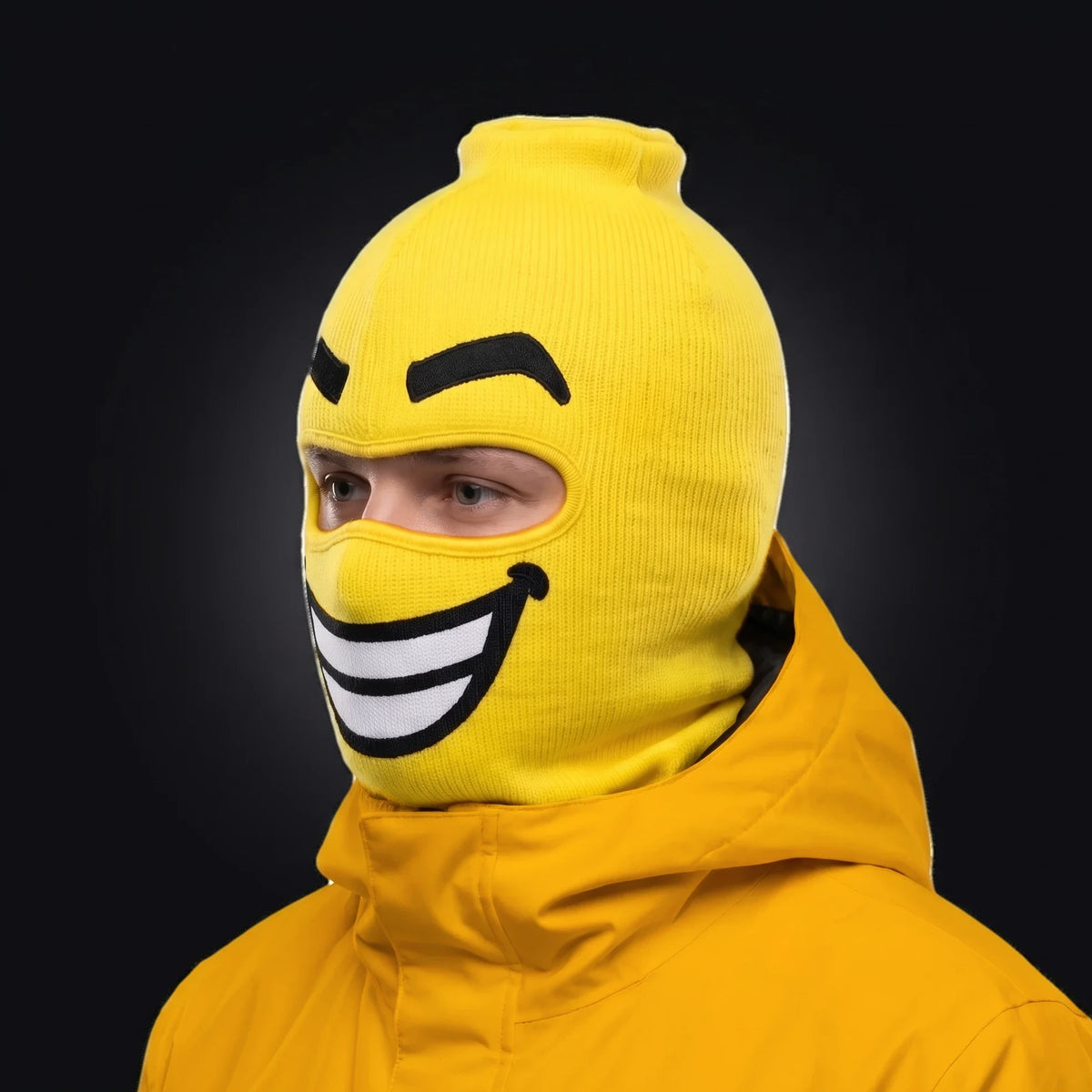 Three-quarter view of the Beamer ski mask pulled over the head, ears and neck, worn with a Goon Yellow jacket.