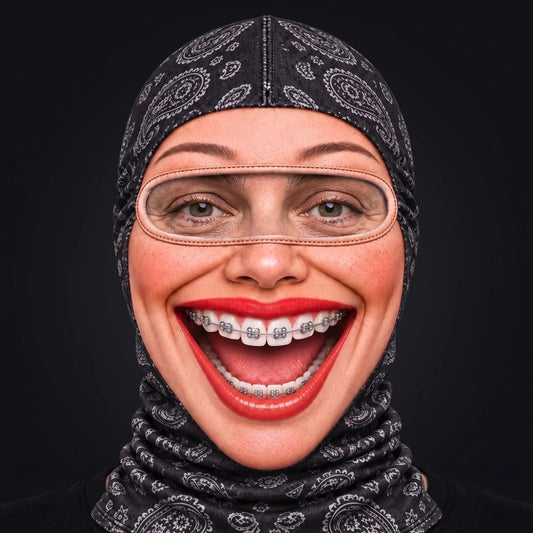 Person wearing the Brenda Braces ski mask, straight-on, real eyes visible through the open oval eye window.