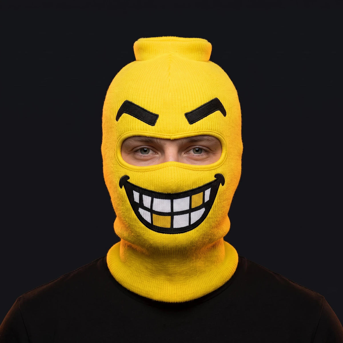 Person wearing the Chompers ski mask, straight-on, real eyes visible through the open eye opening.